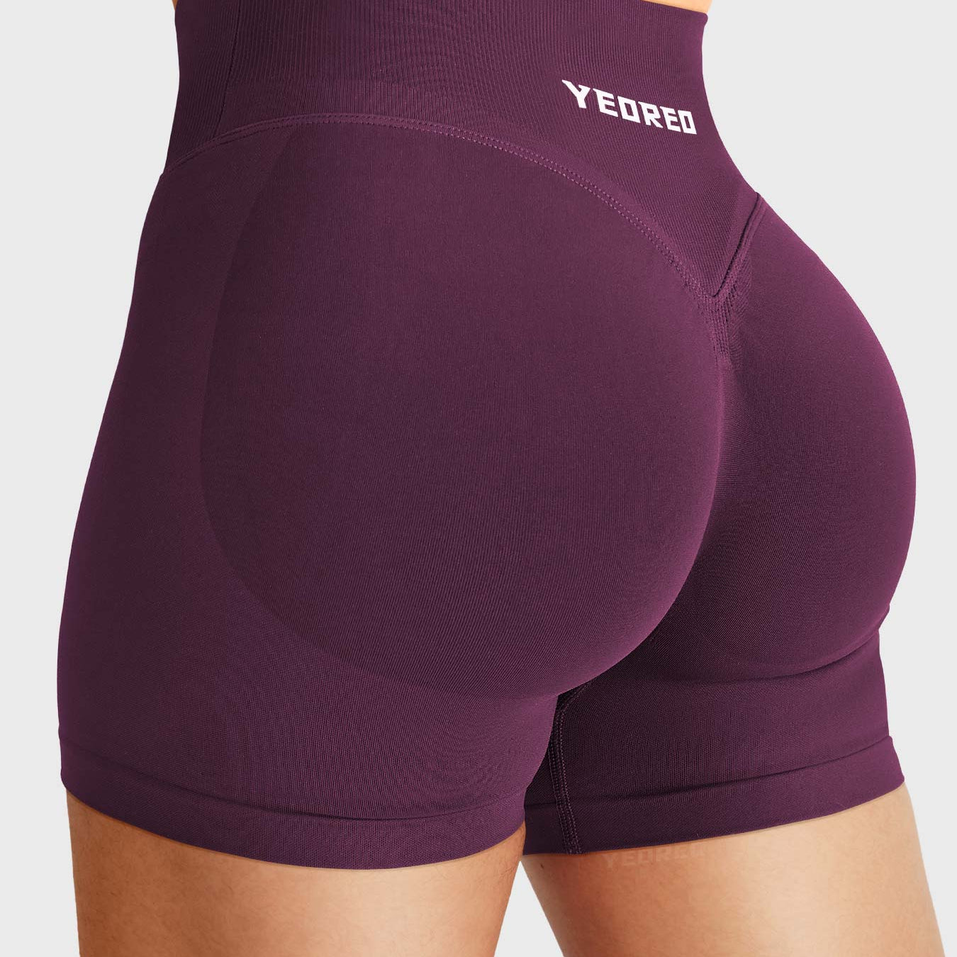 Black Cherry Baderiy 4.5" V-waistband seamless shorts angled back view, subtle glute contour for natural butt lift