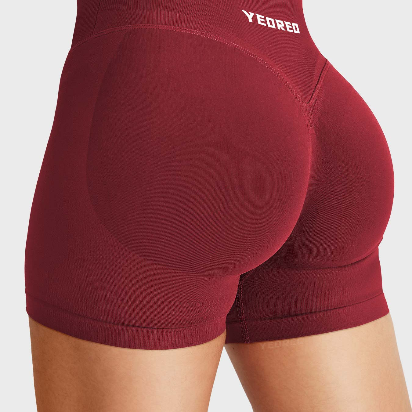 Scarlett Red Baderiy 4.5" V-waistband seamless shorts angled back view, subtle glute shaping with natural butt lift