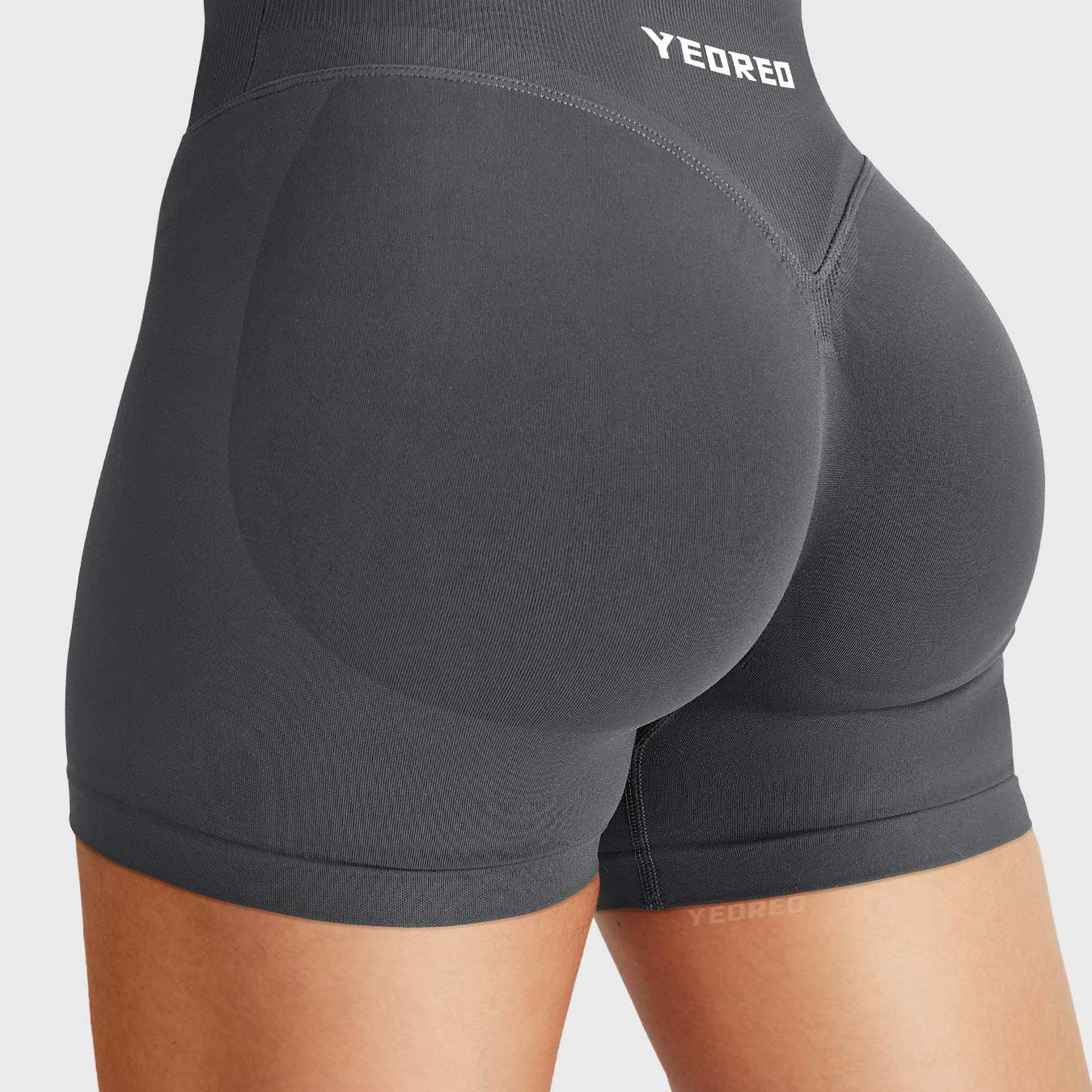 Dark Grey Baderiy 4.5" V-waistband seamless shorts angled back view, natural glute contour with subtle lift