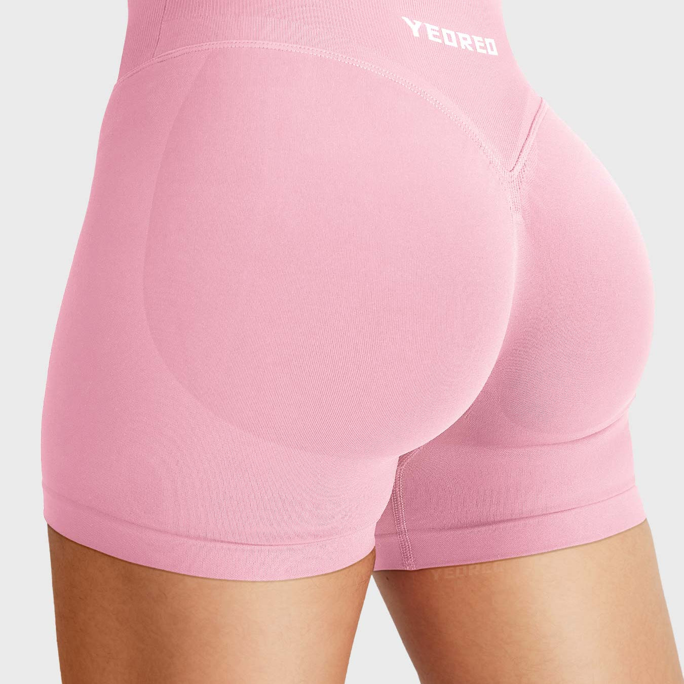 Pink Baderiy 4.5" V-waistband seamless shorts angled back view, soft glute contour for a naturally lifted look