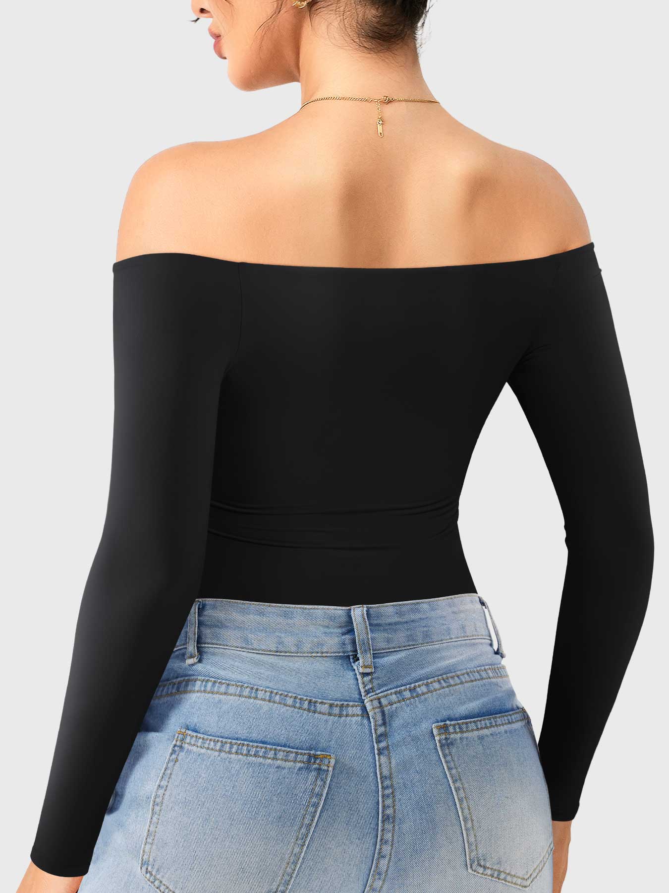 Dacrly Off Shoulder Bodysuit in black, back view layered with jeans, slim fit silhouette, street-ready styling