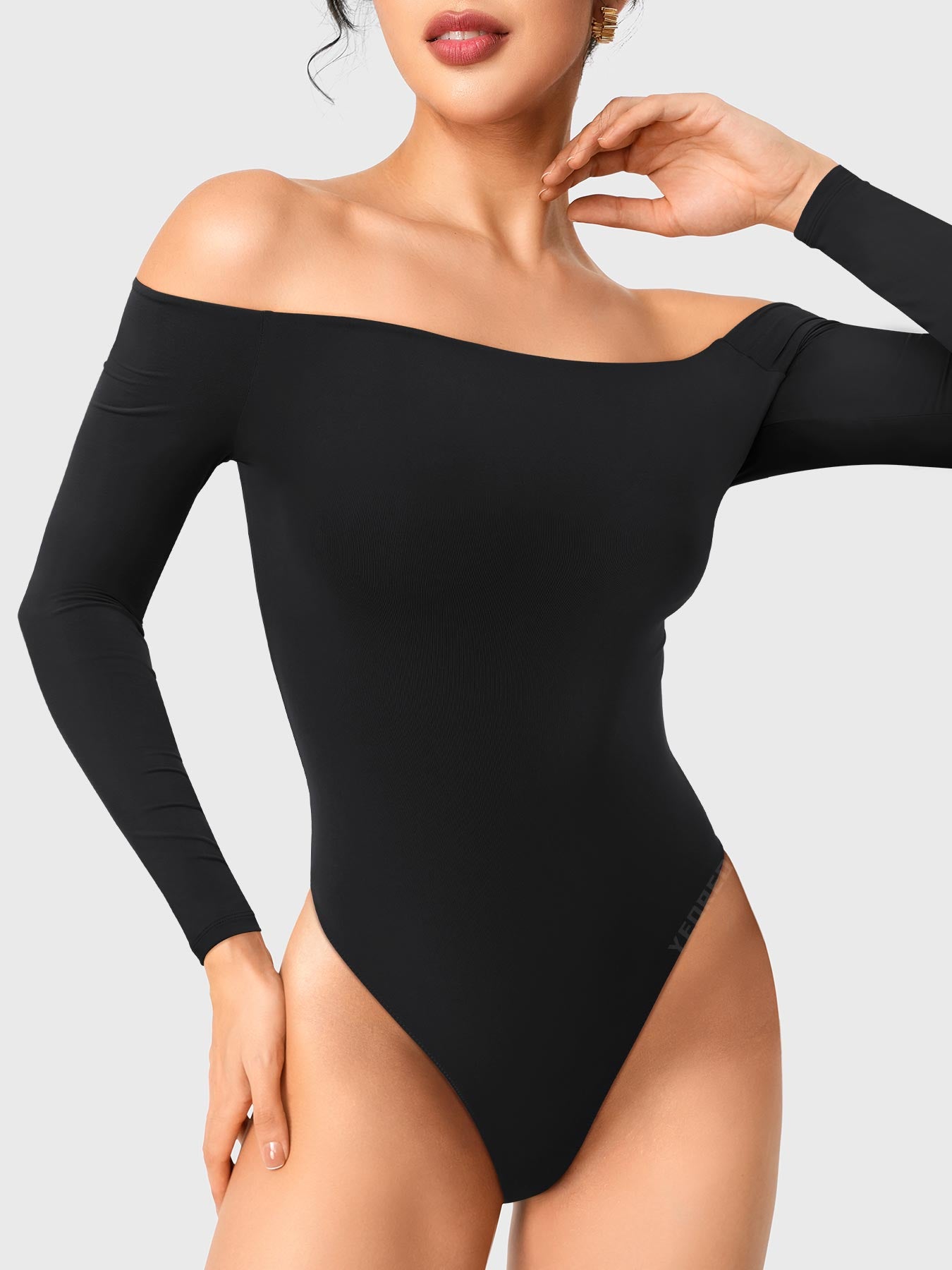 Dacrly Off Shoulder Bodysuit in black, front view with hand touching neck, off shoulder neckline creating elegant neckline