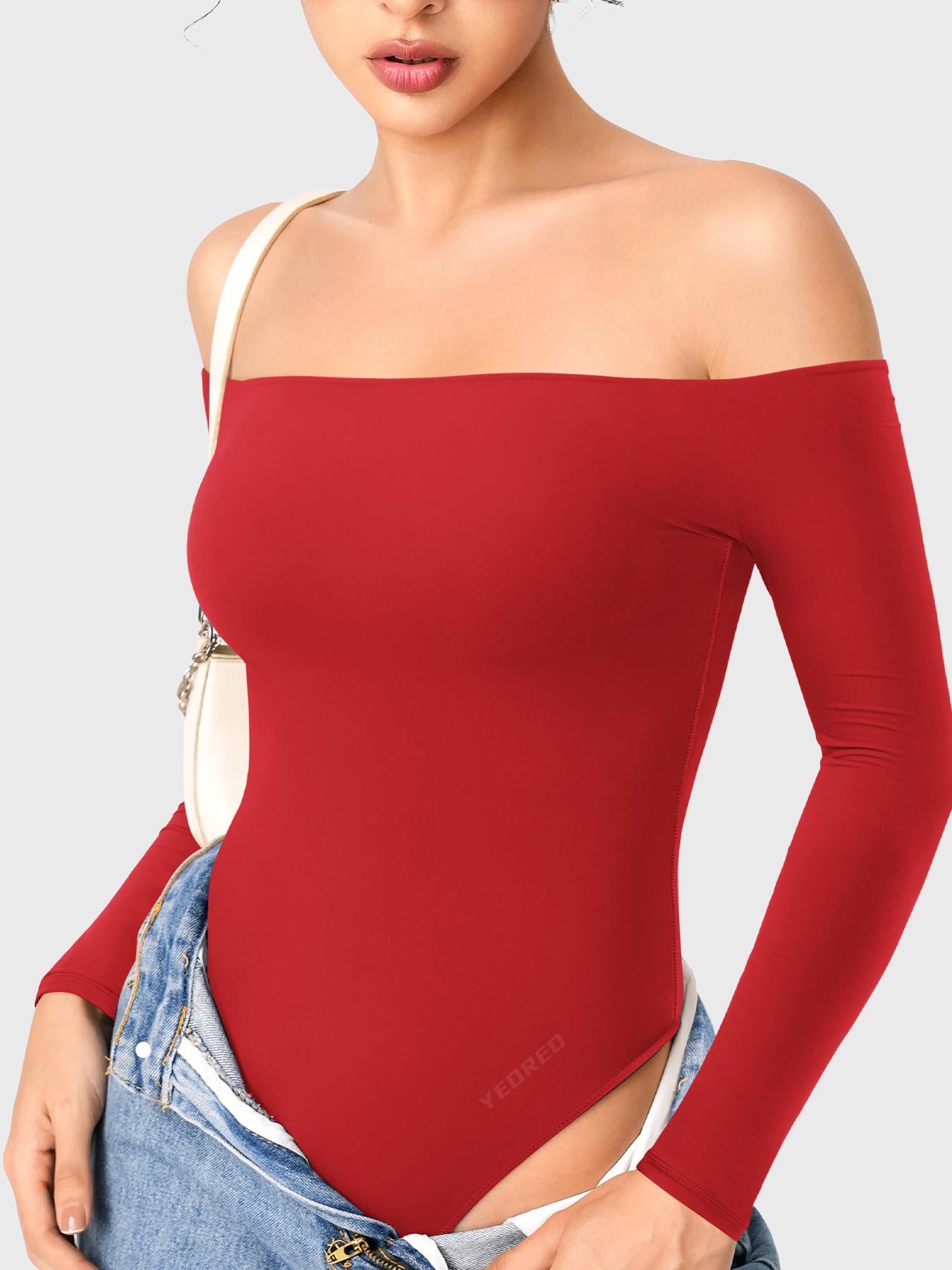 Dacrly Off Shoulder Bodysuit in red, angled front view layered with jeans, off shoulder top styling, Y2K outgoing look