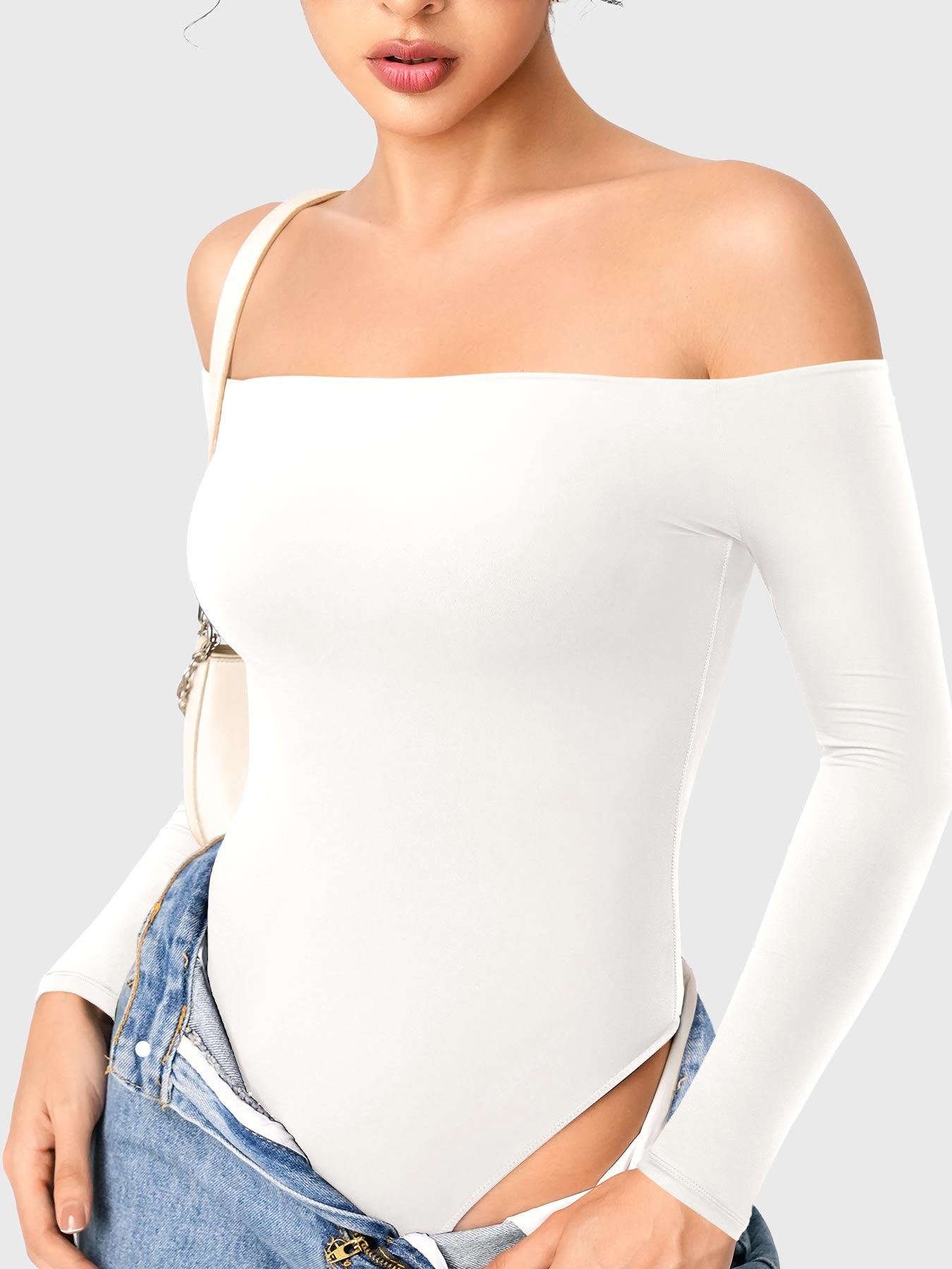 Dacrly Off Shoulder Bodysuit in white, angled front view layered with jeans, off shoulder styling, Y2K outgoing look
