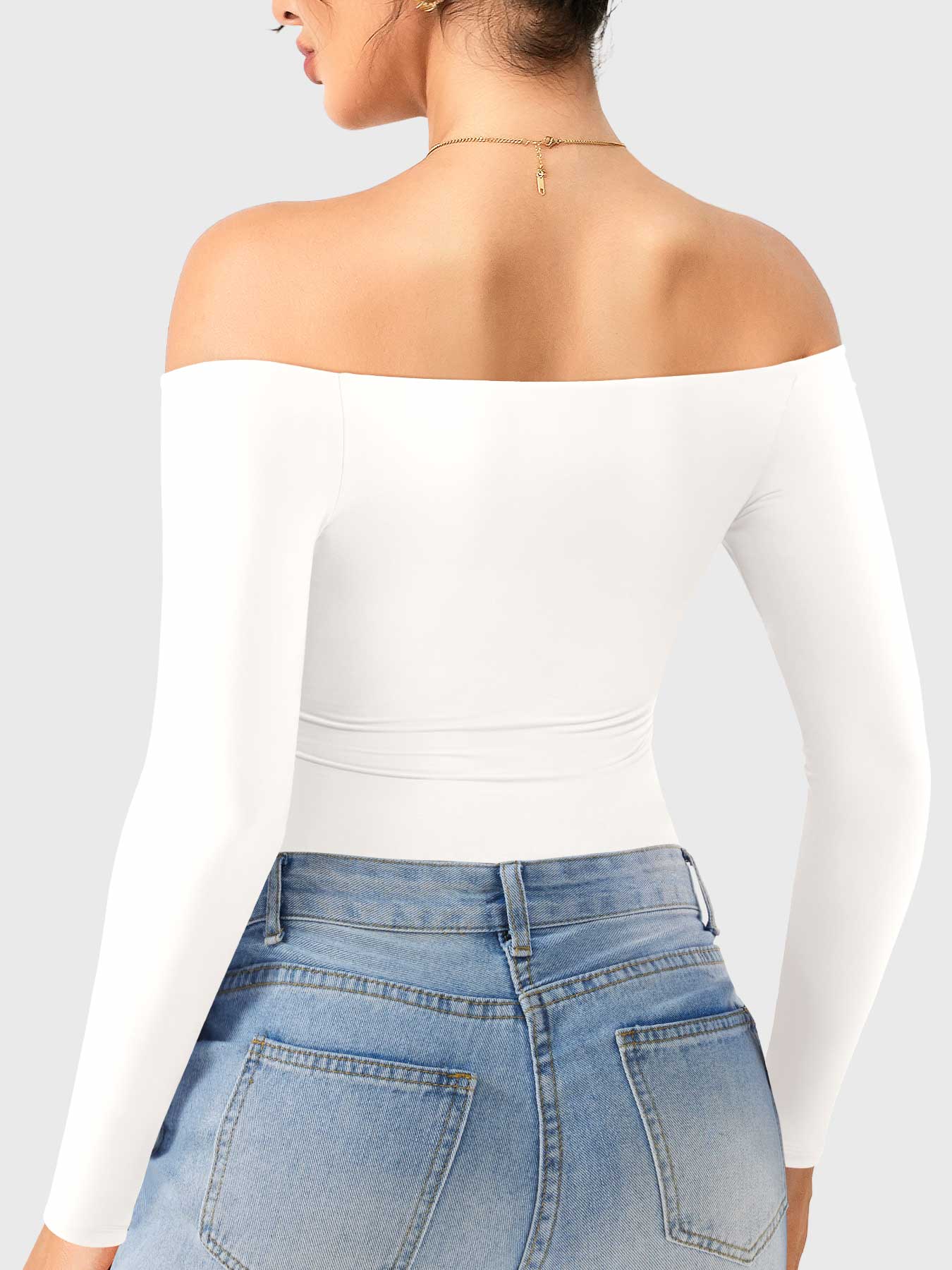 Dacrly Off Shoulder Bodysuit in white, back view layered with jeans, slim fit bodysuit for casual street wear