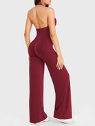 Side-front stretch pose wearing anchor red halter straight-leg jumpsuit