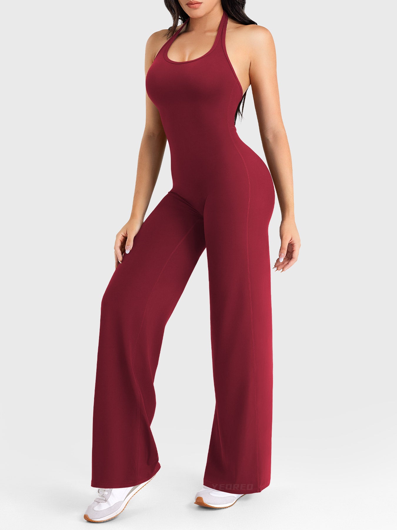 Side-front stretch pose wearing anchor red halter straight-leg jumpsuit