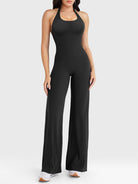 Front view—model wearing black halter open-back straight-leg jumpsuit