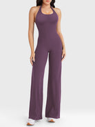 Front view—model wearing black berry halter open-back straight-leg jumpsuit