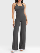 Front view—model wearing dark grey halter open-back straight-leg jumpsuit