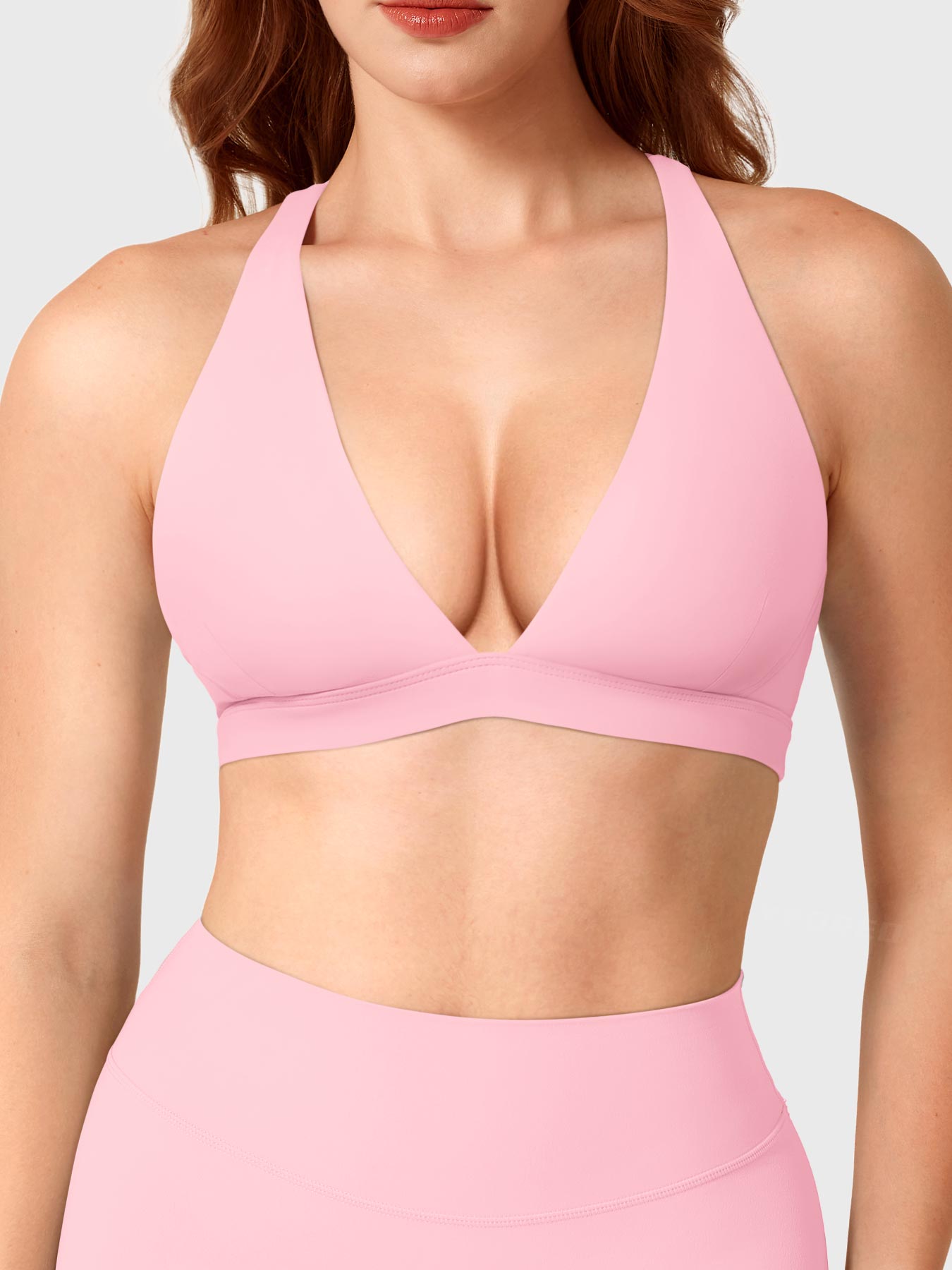 Baby Pink Yeoreo Wafiya cross back sports bra front view, plunge V-neck design with elastic underband support