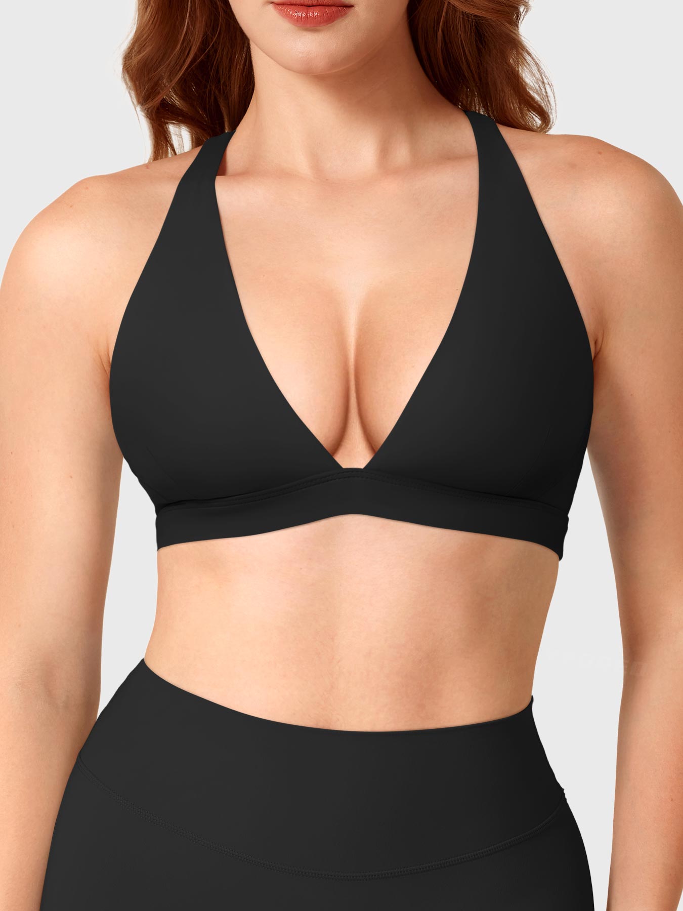 Black Yeoreo Wafiya cross back sports bra front view, plunge V-neck with supportive elasticated underband