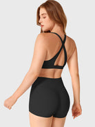 Black Yeoreo Wafiya cross back sports bra angled back view paired with coordinated shorts