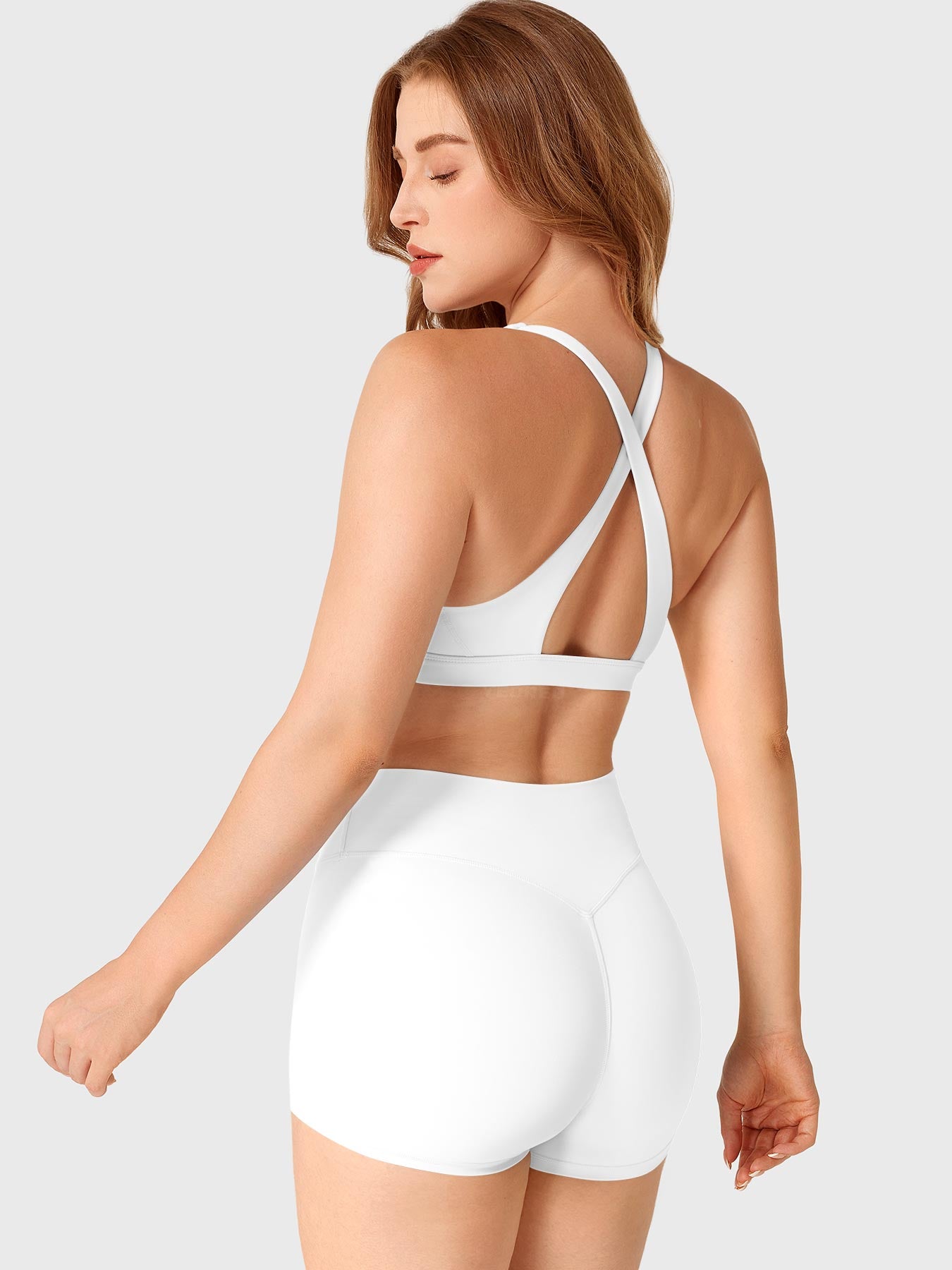 White Yeoreo Wafiya cross back sports bra angled rear view paired with matching set for active look