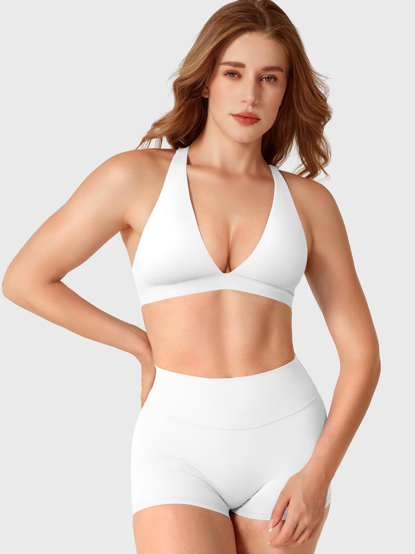 White Yeoreo Wafiya V-neck sports bra front angle styled with matching shorts, smooth athletic silhouette