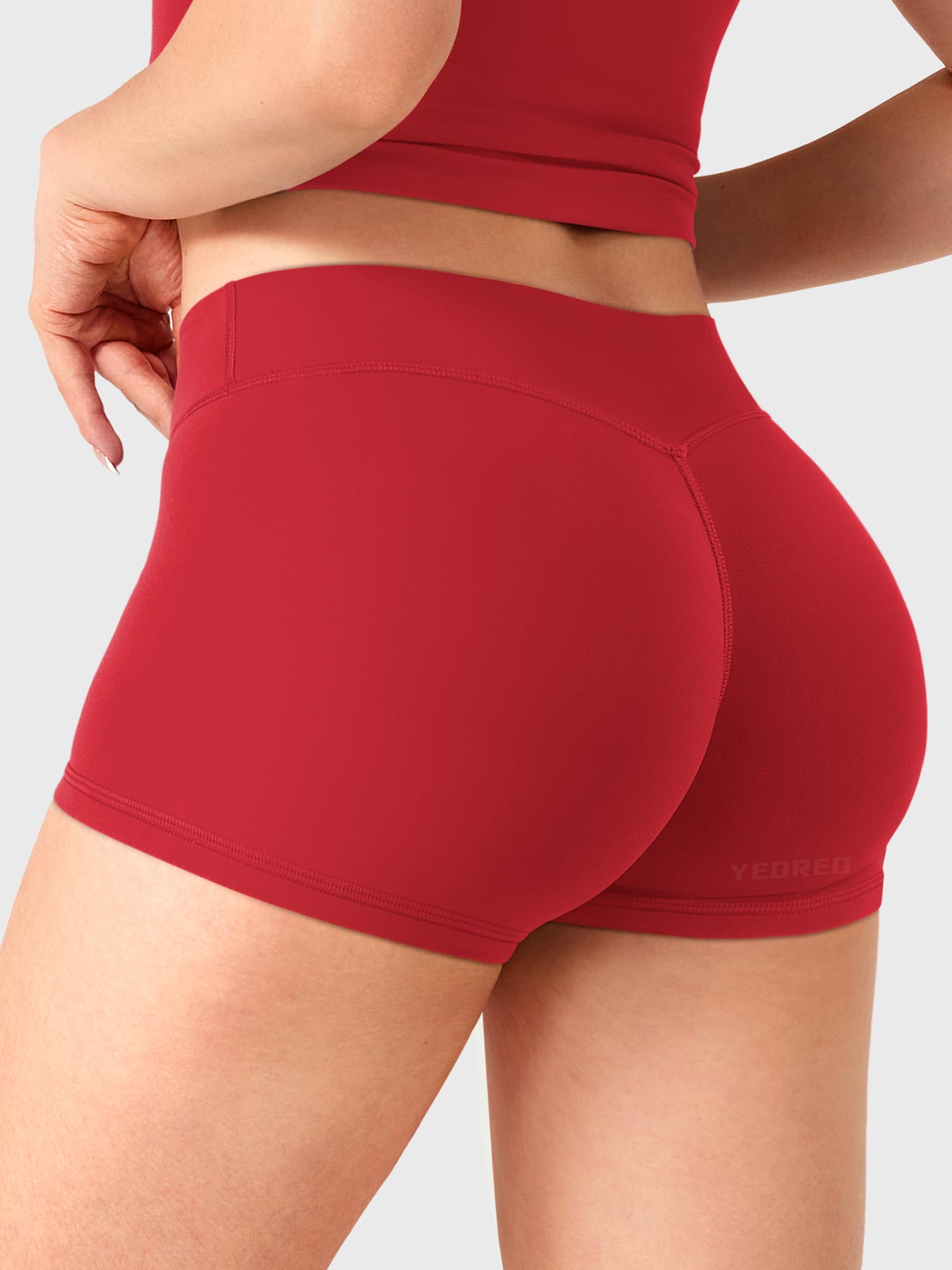 Red Yeoreo Zahida 2.5 inch low rise shorts angled back view, V-back contour enhancing glute shape