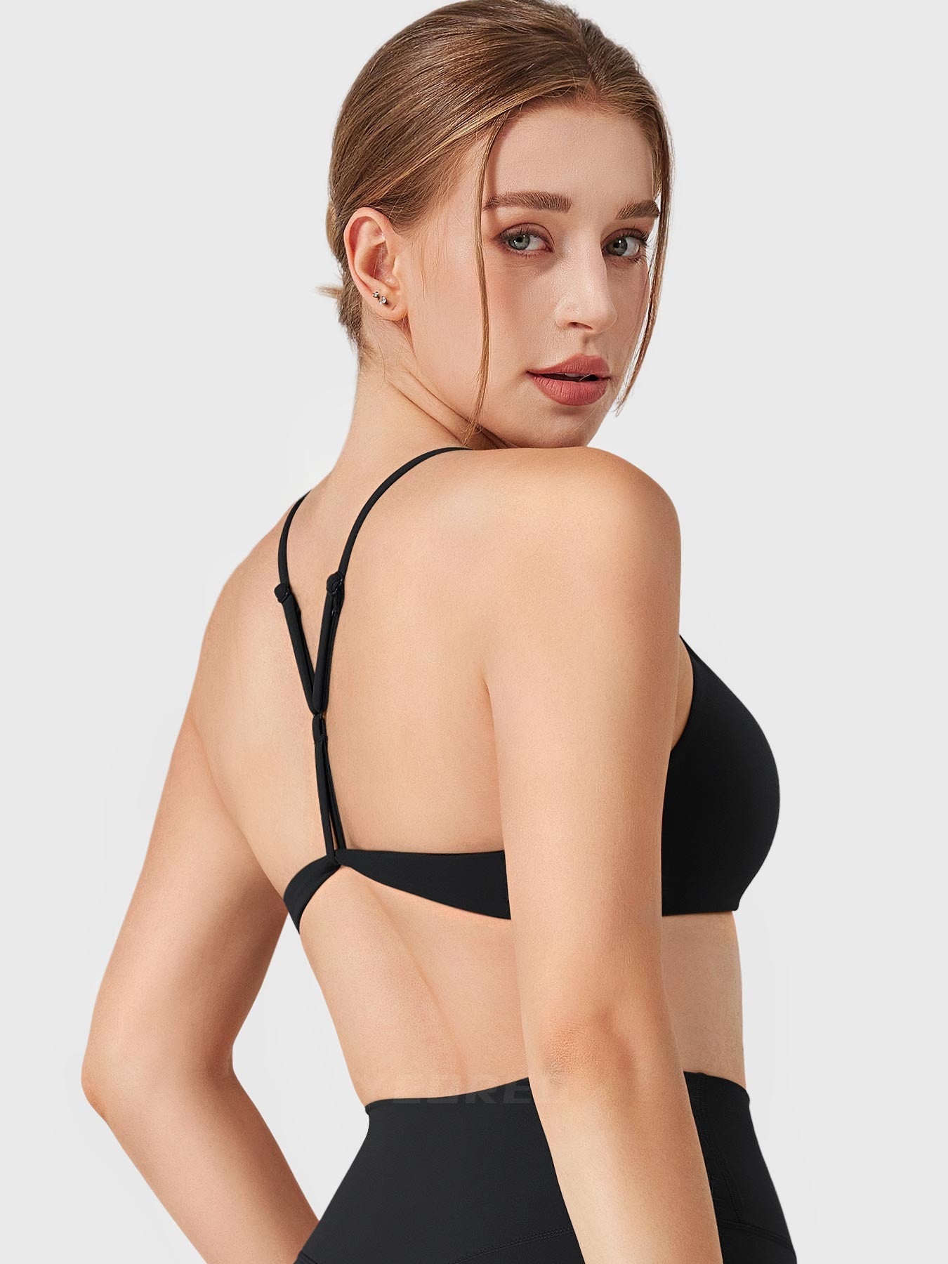 Black Yeoreo Zaahira adjustable Y-back sports bra angled back view, supportive open back design