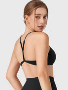 Black Yeoreo Zaahira adjustable Y-back sports bra angled back view, supportive open back design