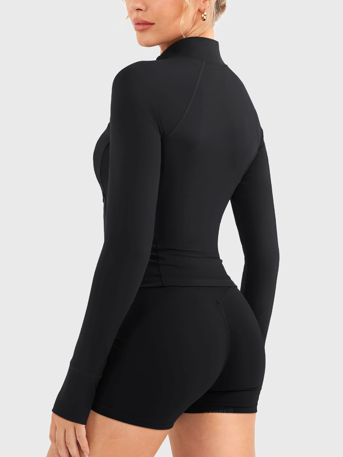 Candecy Full Zip Workout Jacket in black, angled back view, smooth back panel design, clean and fitted cut