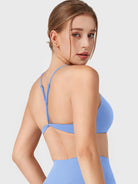 Ice Blue Yeoreo Zaahira adjustable Y-back sports bra angled back view, open back silhouette with supportive fit