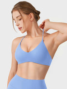 Ice Blue Yeoreo Zaahira V-neck sports bra angled front view, elastic strap stretch detail
