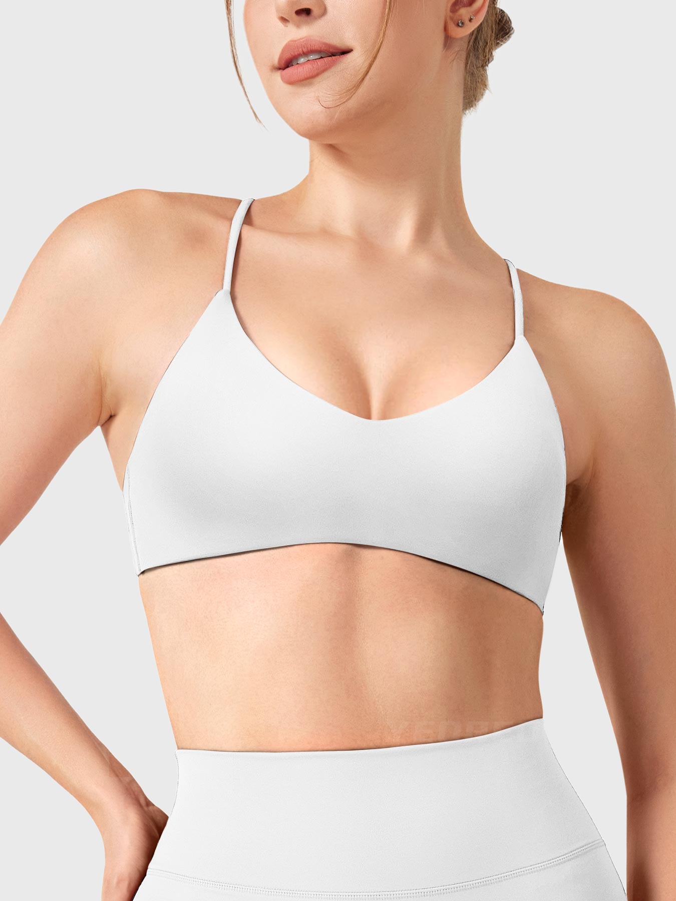 White Yeoreo Zaahira V-neck sports bra front view, elegant neckline enhancing posture and upper body lines