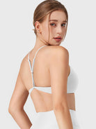 White Yeoreo Zaahira adjustable Y-back sports bra angled rear view, sleek supportive athletic silhouette