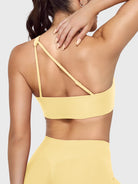 Claranie One Shoulder Sports Bra in milk yellow, angled back upper body view, side coverage support, elegant open back design