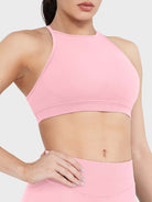 Acuffny High Neck Backless Sports Bra in pink, angled front upper body view, flattering bust contour, smooth supportive silhouette
