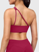 Claranie One Shoulder Sports Bra in ruby red, angled back view upper body, open back design with adjustable strap, elegant and breathable