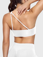 Claranie One Shoulder Sports Bra in white, angled back upper body view, supportive side coverage, refined open back design