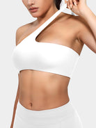 Claranie One Shoulder Sports Bra in white, angled front upper body view, model stretching shoulder strap to show elasticity