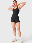 Black Yeoreo Daiane halter neck romper full length view, sculpting athletic one piece shorts outfit