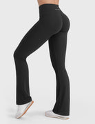 Black V-back booty-enhancing flare leggings, angled back pose