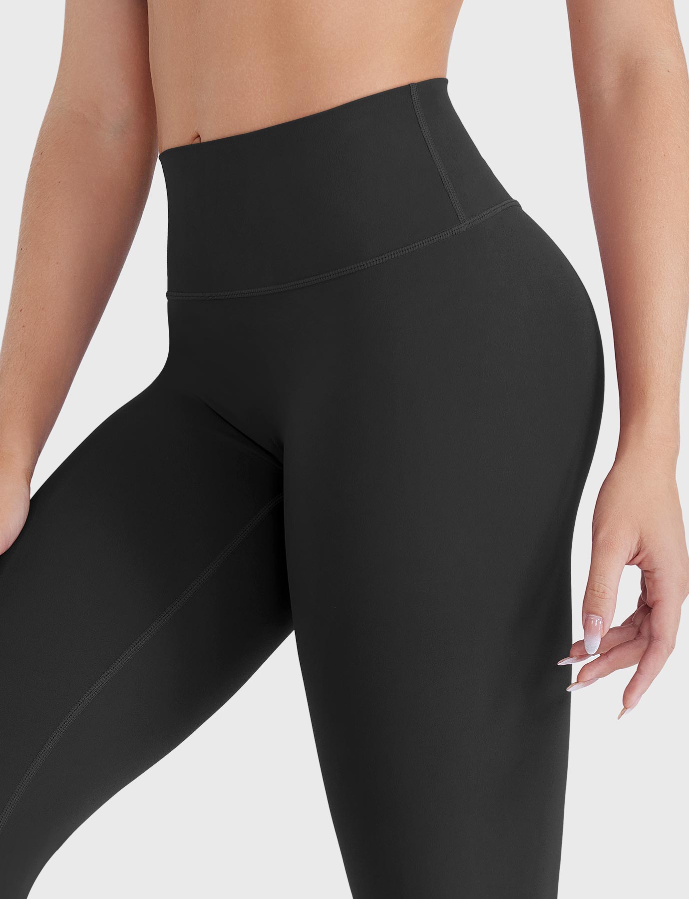 Close-up of black high-rise no-front-seam leggings, waist detail