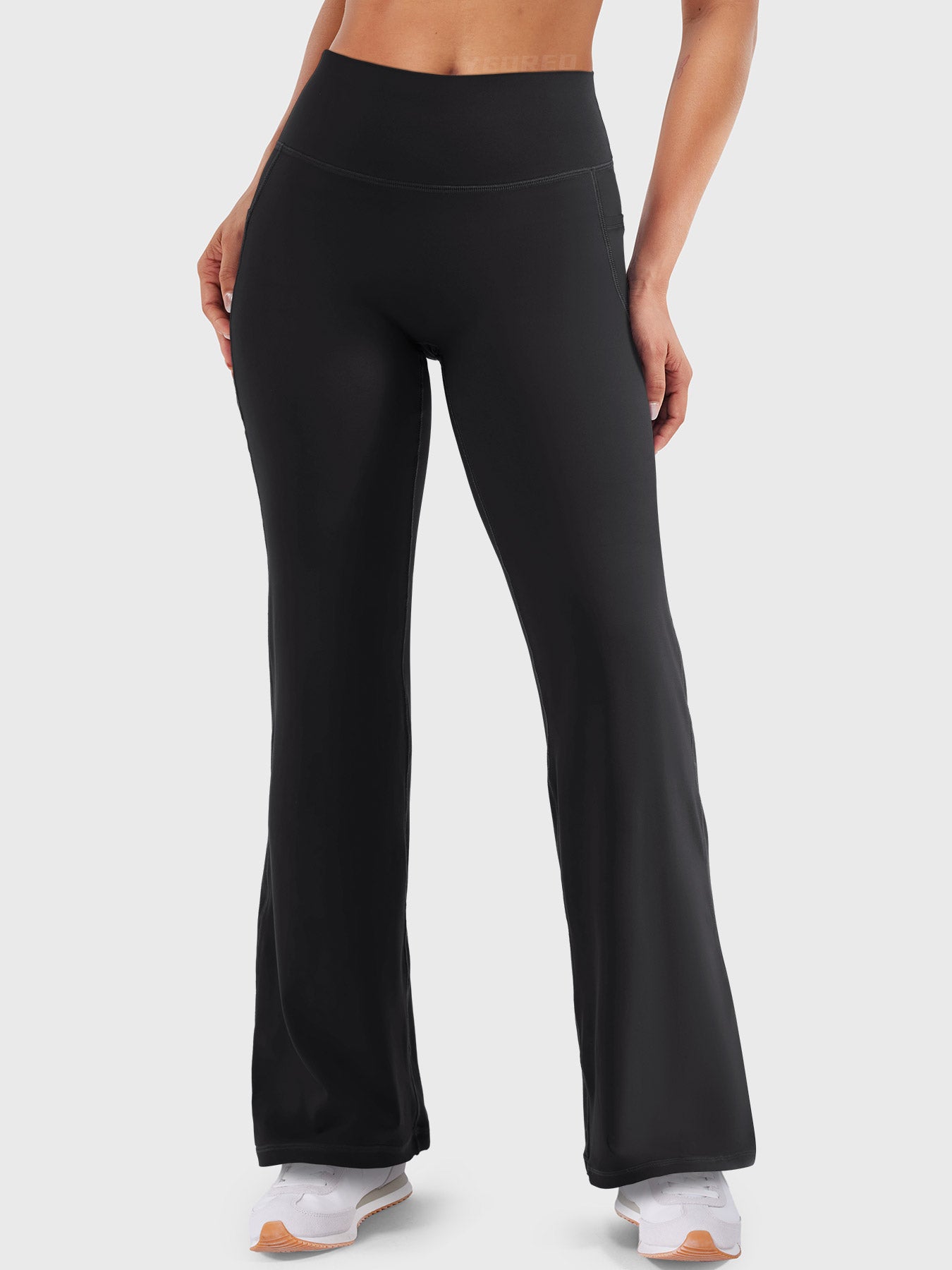Front view—model wearing black high waisted straight leg leggings with no front seam, 29-inch inseam