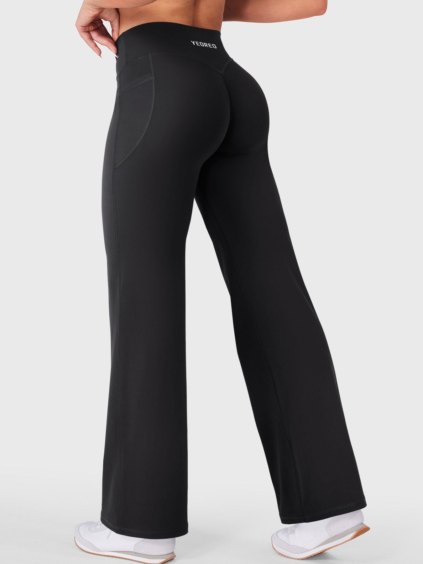 Walking side-back view in black straight leg leggings with pockets, everyday athleisure look