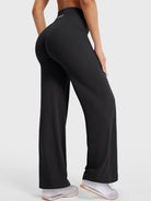 Side-back view showing black straight leg leggings with V-back shaping and smooth fit