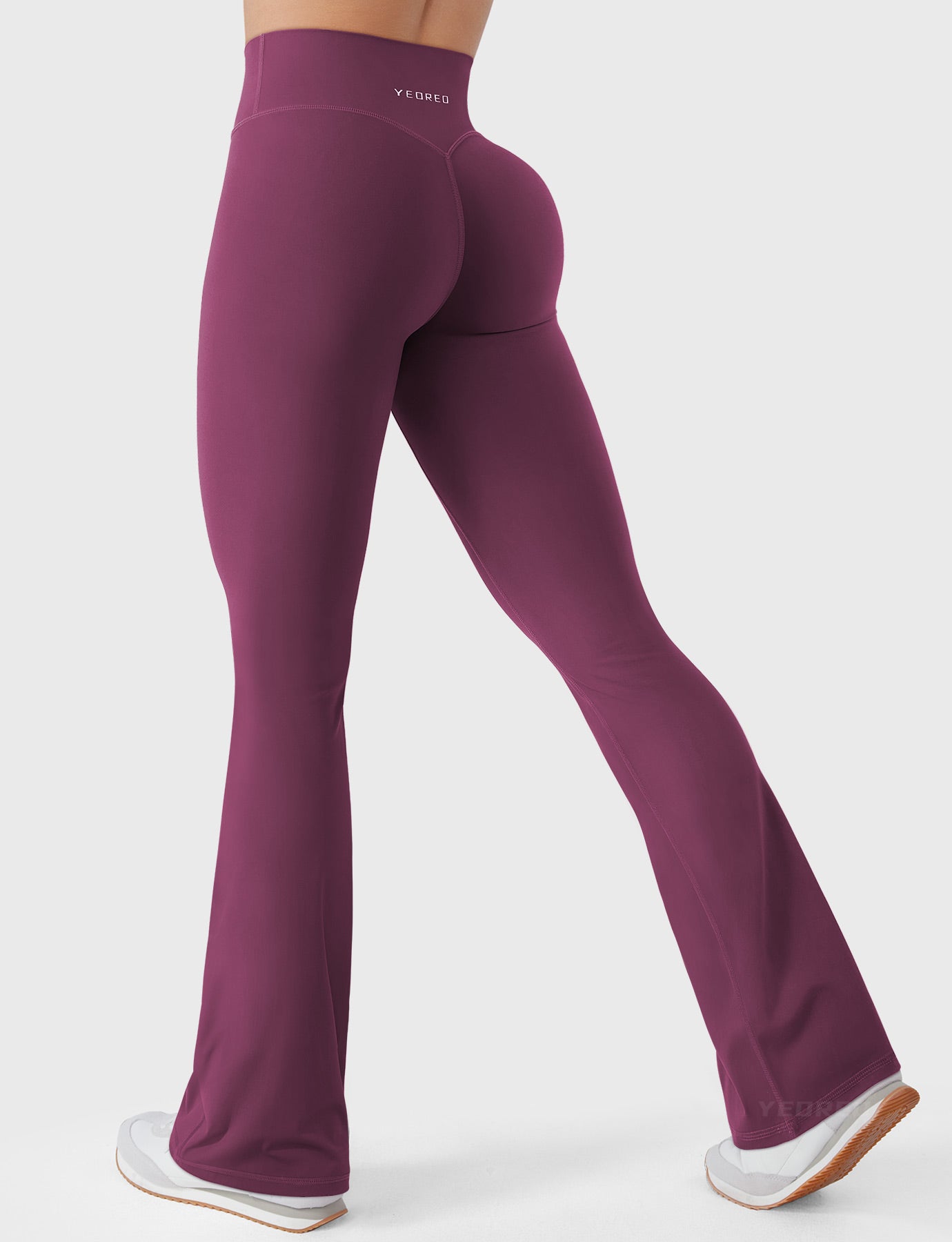 Deep Cherry Red bootcut mini flare leggings with V-back hidden scrunch, walking pose