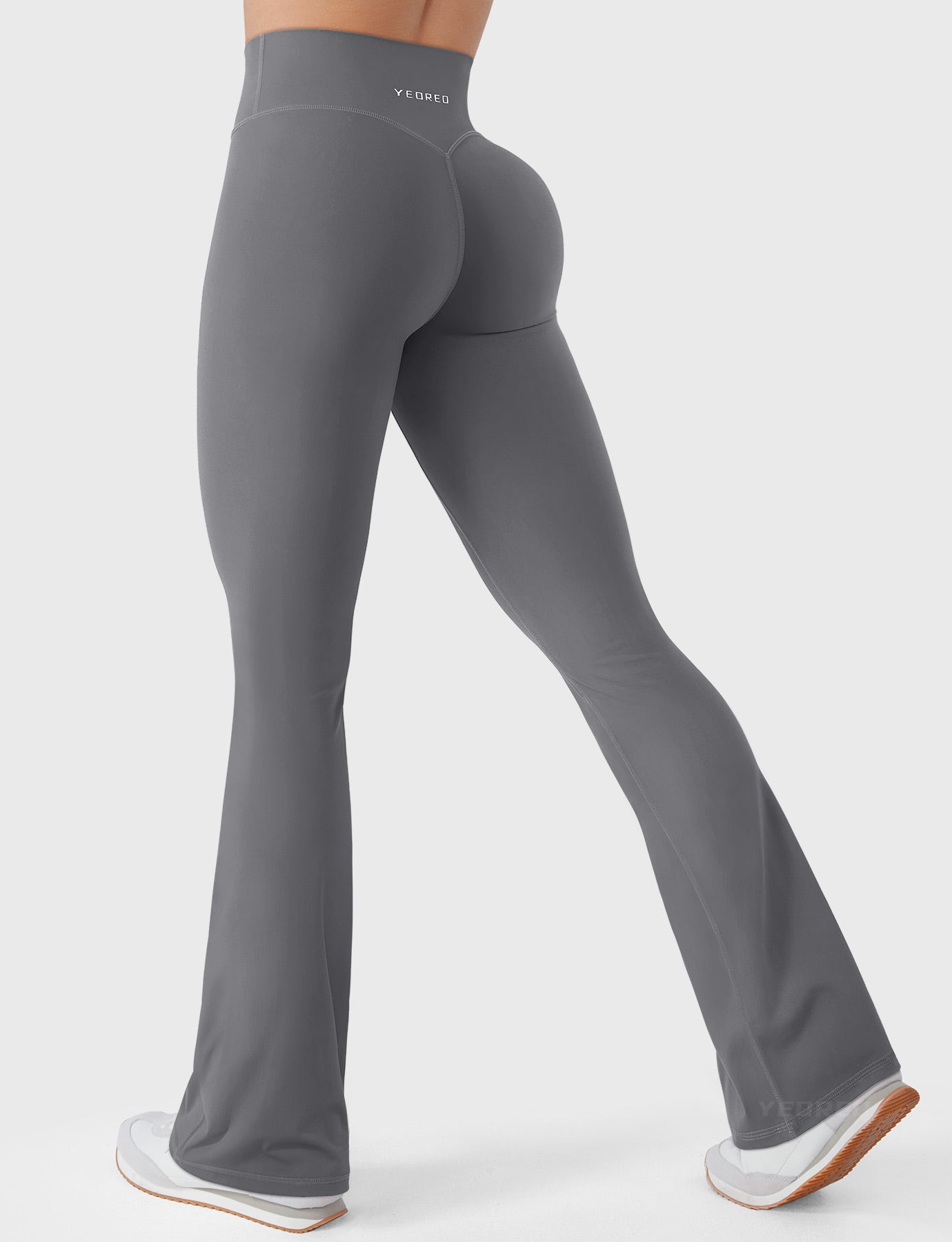 Lara Smoke bootcut mini flare leggings with V-back hidden scrunch, walking side-back pose