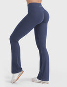 Navy V-back booty-lifting flare leggings, angled back pose