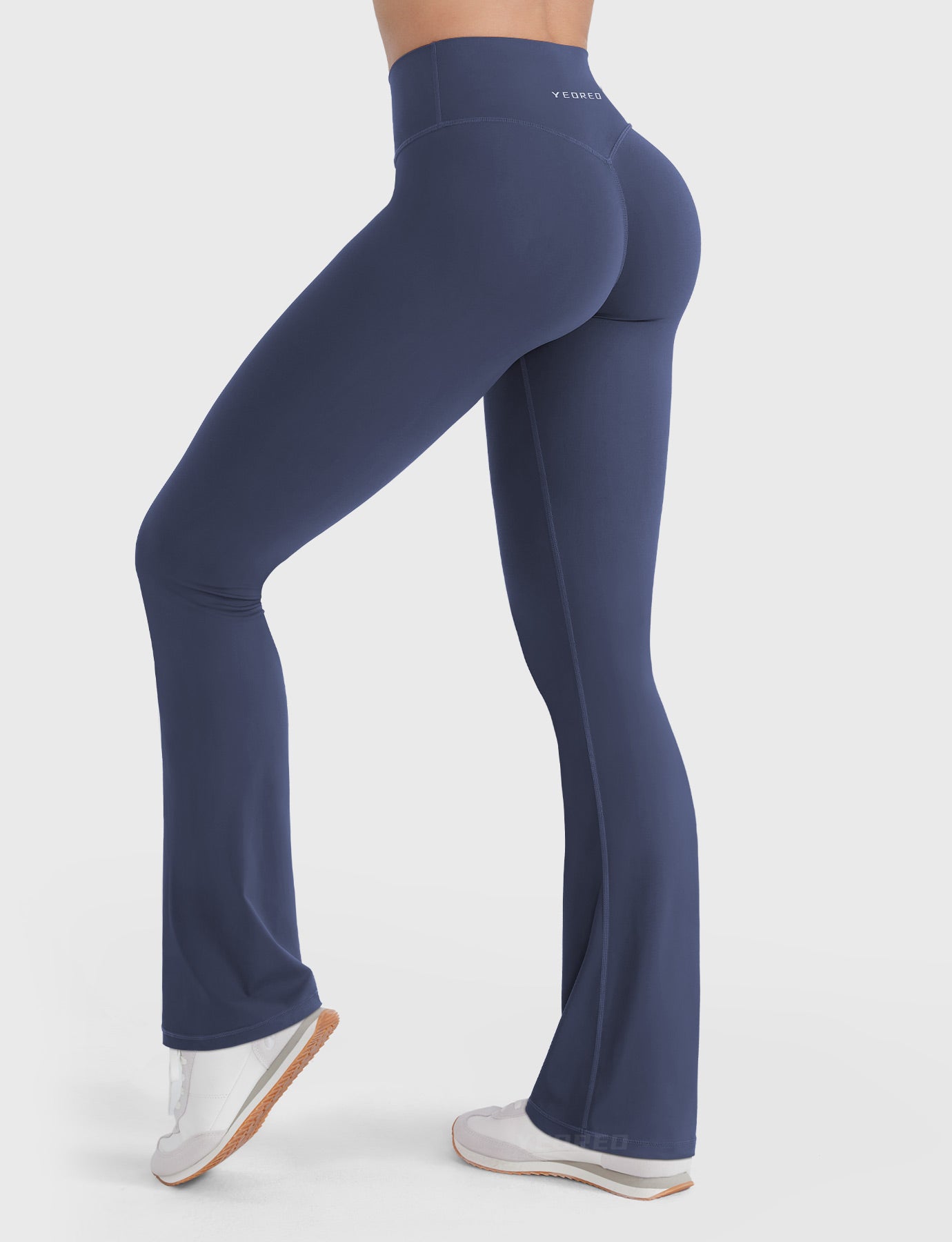 Navy V-back booty-lifting flare leggings, angled back pose