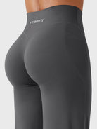 Back-angle close-up showing V-back detail and natural shaping in dark grey leggings