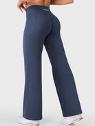 Walking side-back view in navy straight leg leggings with pockets, gym-to-street athleisure style