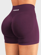 Black Cherry Baderiy 4.5" V-waist seamless shorts angled back view, seamless fit enhancing natural curves