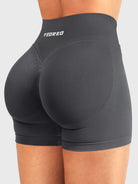 Dark Grey Baderiy 4.5" V-waist seamless shorts angled back view, seamless compression enhancing natural curves