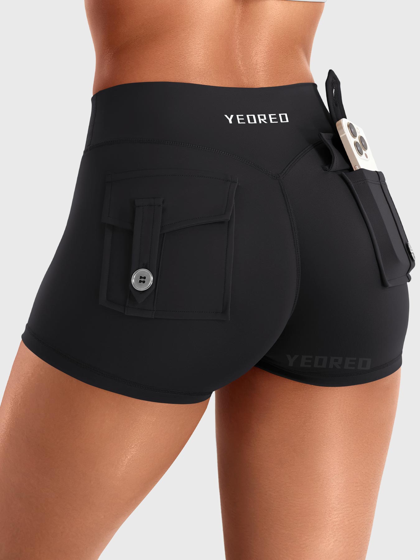 Black Yeoreo Darilya CoreFlex Y2K cargo shorts angled back view, utility flap pockets and fitted silhouette