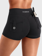 Black Yeoreo Darilya CoreFlex Y2K cargo shorts angled back view, utility flap pockets and fitted silhouette