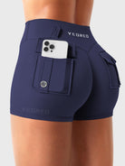 Navy Yeoreo Darilya CoreFlex low rise cargo shorts angled back view, dual cargo pockets with functional utility design