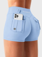 Light Blue Yeoreo Darilya CoreFlex low rise cargo shorts angled back view, dual rear cargo pockets with functional storage